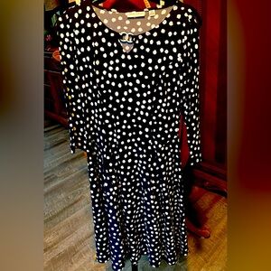 Traditional blue and white polka dot A line dress with silver trim neckline.